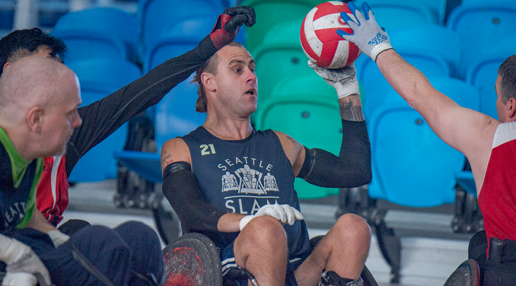 A Seattle player looks to pass as defenders put hands in his way.